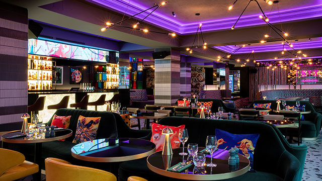 Eat Drink & Play at the NYX Hotel © Jurys Inn & Leonardo Hotels UK and Ireland. Image courtesy of Jurys Inn & Leonardo Hotels UK and Ireland. The colourful and eclectic interior of the Eat Drink & Play bar and restaurant at the NYX Hotel in the evening.