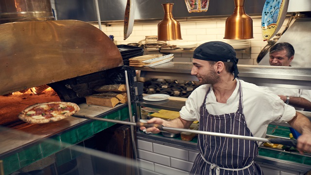 Enticing fresh pizza at Portobello Ristorante Pizzeria. © Portobello Ristorante Pizzeria / Matthew Stansfield A chef putting a fresh pizza into the pizza oven