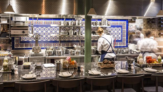 Sabor. Photo: Chris Terry. Image courtesy of Sabor. The counter at Sabor in Heddon Street, with servers facing blue and white tiles on the back wall.