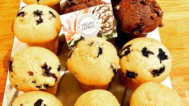 Box of chocolate chip muffins with a business card from Vegan Express.