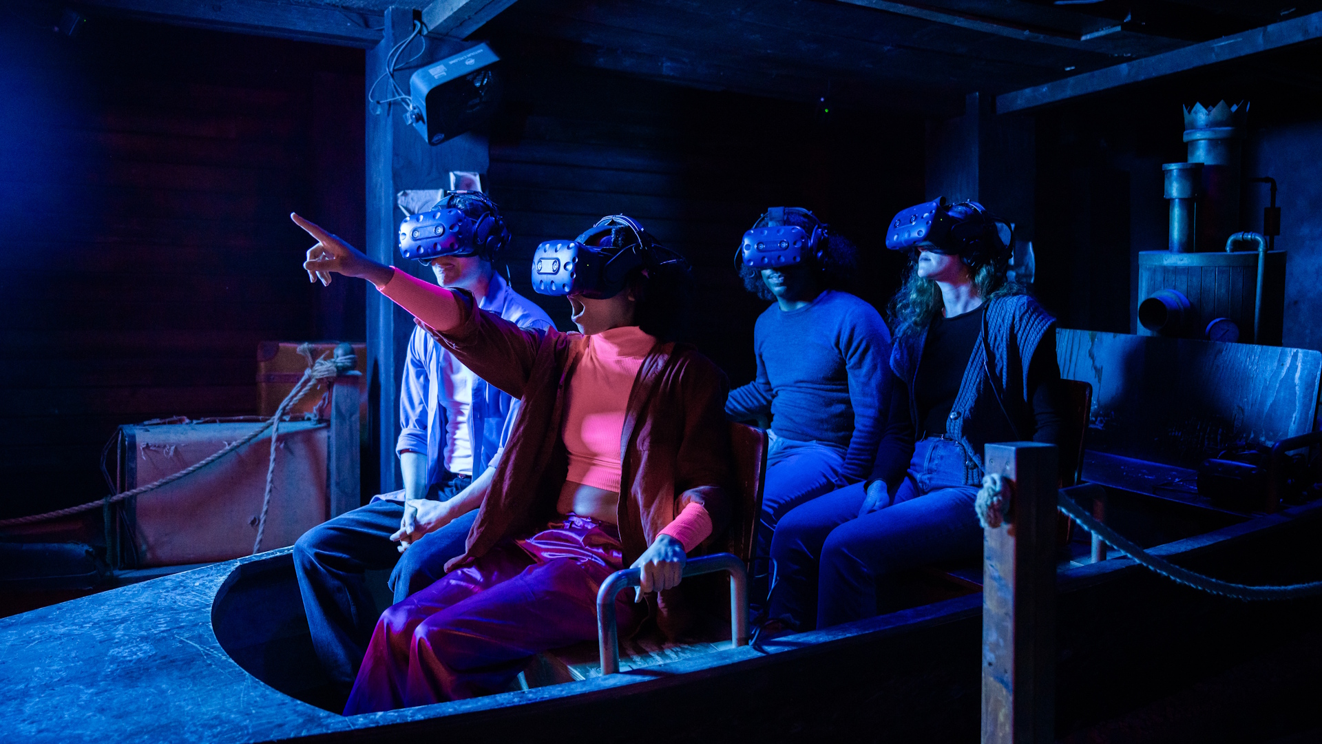 Enjoy a boat ride down the Thames thanks to VR headsets at The War of the Worlds: The Immersive Experience. Credit: Layered Reality. Image courtesy of Layered Reality. Four people enjoying a virtual reality ride on a boat in immersive experience with VR headsets.