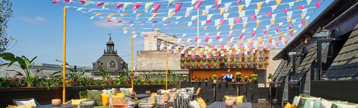 A mixologist makes a cocktail on the rooftop bar of Aqua Nueva in London. 