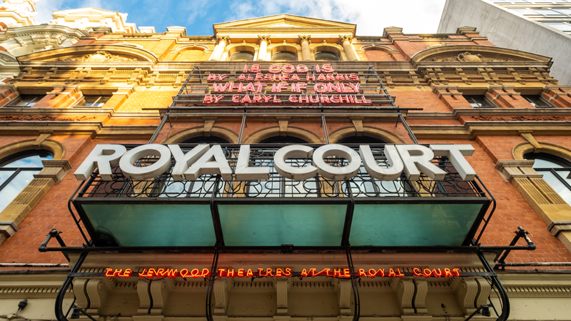 See famous and up-and-coming talent perform at the Royal Court Theatre in Chelsea. Credit: Shutterstock. Image courtesy of Shutterstock. A view from the entrance of the Royal Court Theatre looking up at the building's exterior with signs of the building's name and what's on on a sunny day