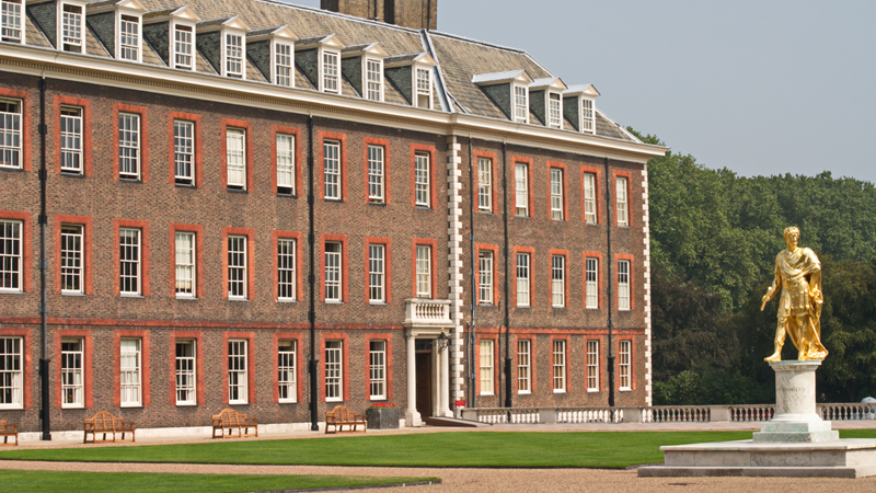 Take in the history of the Royal Hospital Chelsea during a Scarlet Tour. Credit: Shutterstock. Image courtesy of Shutterstock. The grand Royal Hospital Chelsea building with very well maintained grass outside the front and a giant gold Statue of King Charles III