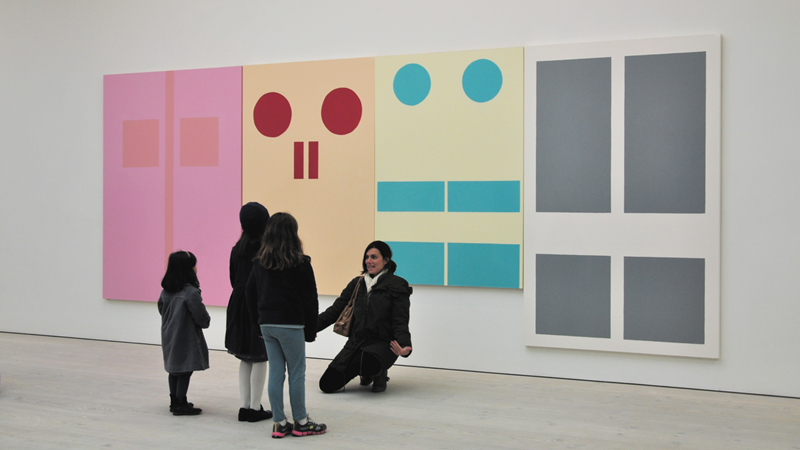 Bring the whole family for a day out to Saatchi Gallery in Chelsea. Credit: Shutterstock. Image courtesy of Shutterstock. A mother kneels in front of contemporary art at Saatchi Gallery as she gestures for her three young daughters to join her for a photo
