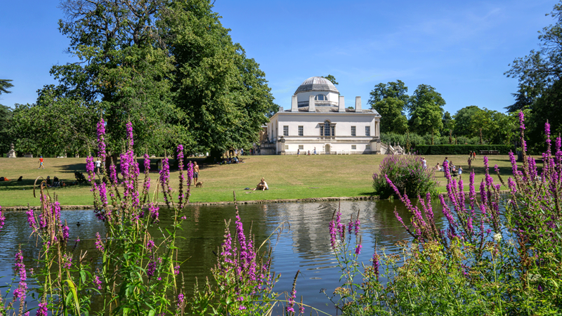 Take in the beauty of Chiswick House and its 65 acres (26 ha) of gardens as it changes with each season. Credit: Shutterstock. Image courtesy of Shutterstock. View of Chiswick House with lake and flowers in front