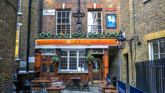 Wooden table and chairs outside the Lamb & Flag pub in Covent Garden, London.