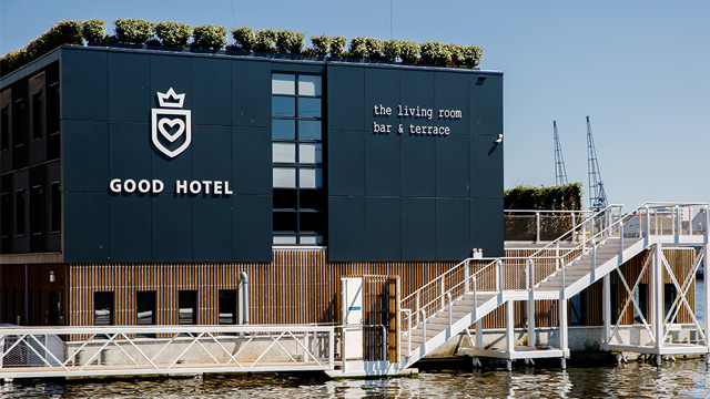 Dark blue front of contemporary floating hotel on the river Thames. 