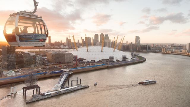 The sun sets in Greenwich over the IFS Cloud Cable Car and The O2.