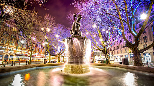 Venus fountain on Sloane Square © Shutterstock. Image courtesy of Shutterstock / Photos.London. The Venus fountain on Sloane Square illuminated in colourful lights at night.