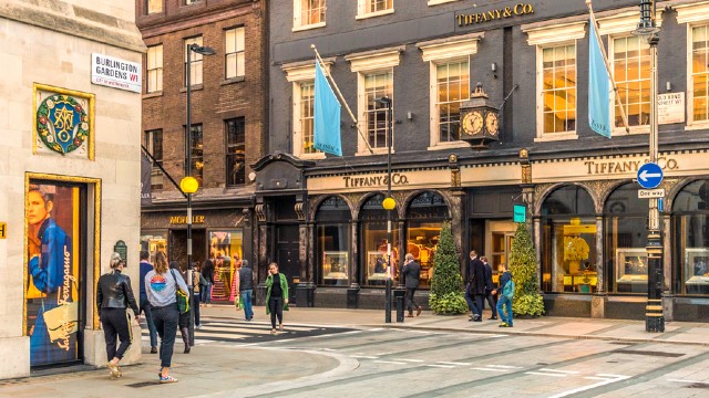 Roam the extravagant streets of London's Mayfair. Image courtesy of Shutterstock. People walking around streets of Mayfair on a sunny day.