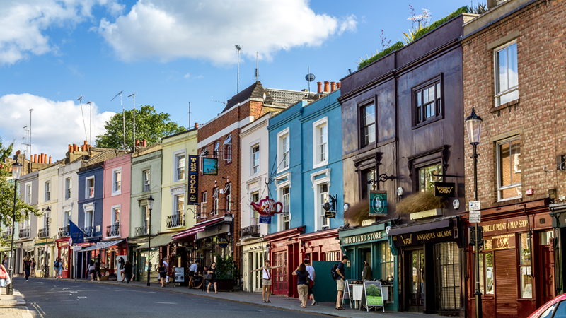 No trip to Notting Hill is complete without a visit to Portobello Road Market for its strong food offering. Credit: Shutterstock. Image courtesy of Shutterstock. Colourful buildings along Portobello Road in Notting Hill, west London, on a sunny day