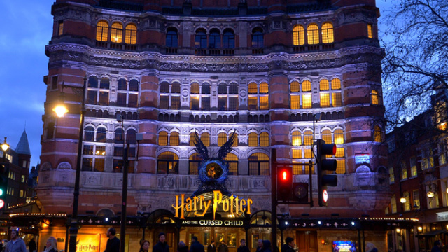The Palace Theatre with Harry Potter and the Cursed Child sign lit up at night in Soho, London.