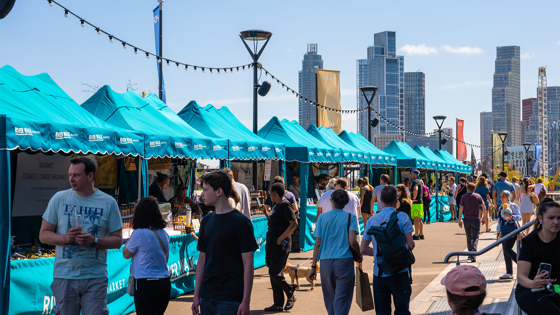 River Walk Market at Battersea Power Station. Image courtesy of Battersea Power Station/Charlie Round-Turner. The River Walk Market at Battersea Power Station pictured against skyline.