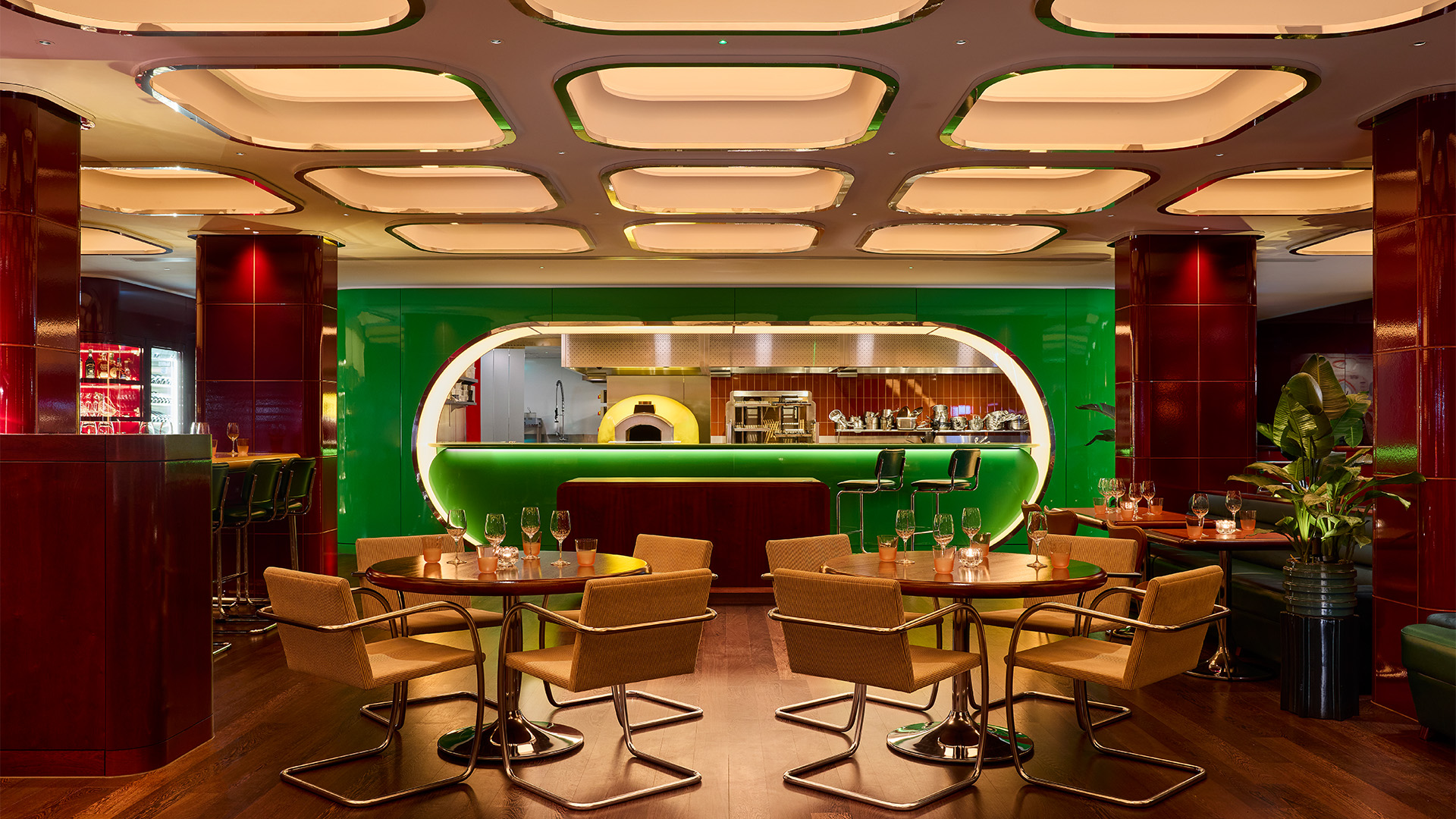 A look inside Town restaurant in Covent Garden. Image courtesy of Town/North End Design. Potted plants, yellow chairs and a green bar decorate the space at Town restaurant