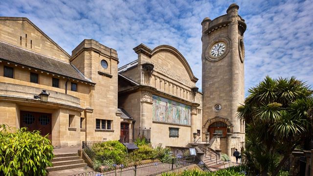 Horniman Museum building and clocktower on a clear day with blue skies and some clouds.