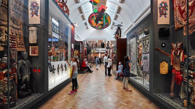 Children admiring colourful exhibits in the Horniman Museum's world-themed gallery.