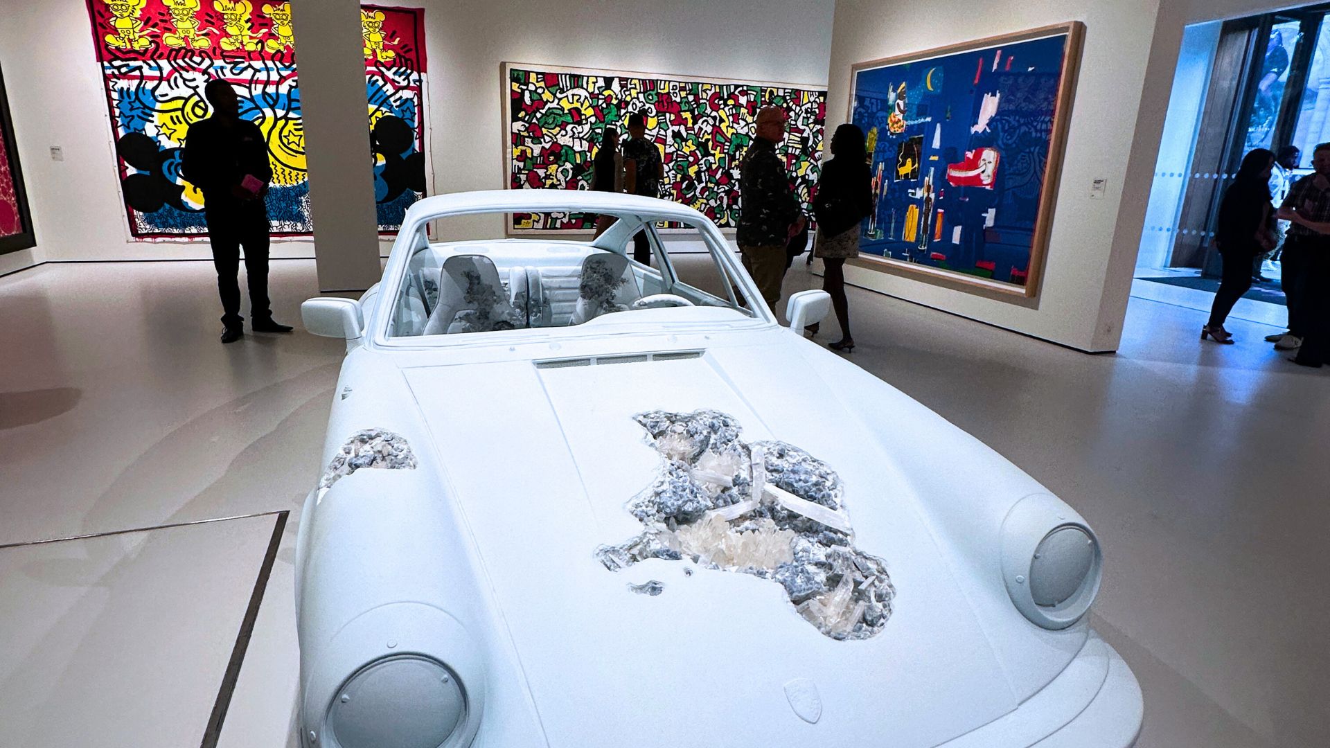 See the work of the Modern Masters at Moco Museum. © Visit London/Kirstine Spicer A large white car with crystals installation on the ground floor of moco museum london