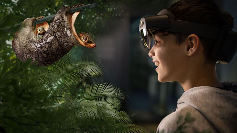 A boy wearing a multi-sensory headset explores the Natural History Museum's new exhibition, Visions of Nature, and comes face to face with a flying lemur.