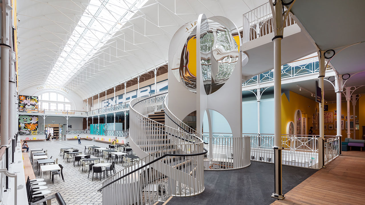 A grey spiralling staircase in the Young V&A Museum