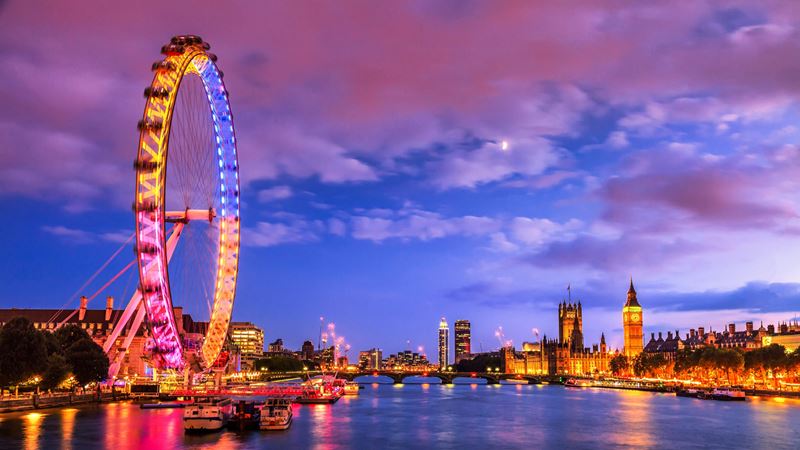 See London through a different lens with these key locations used in the top thriller films. Credit: Shutterstock. Image courtesy of Shutterstock. Views over the river Thames with the Houses of Parliament and the London Eye lit up, as darkness begins to fall over the capital.