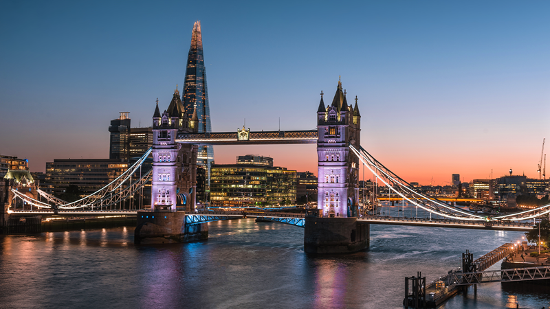 Discover London's iconic landmarks lit up at night. Credit: Shutterstock. Image courtesy of Shutterstock. A shot of Tower Bridge lit up at night with The Shard in the background