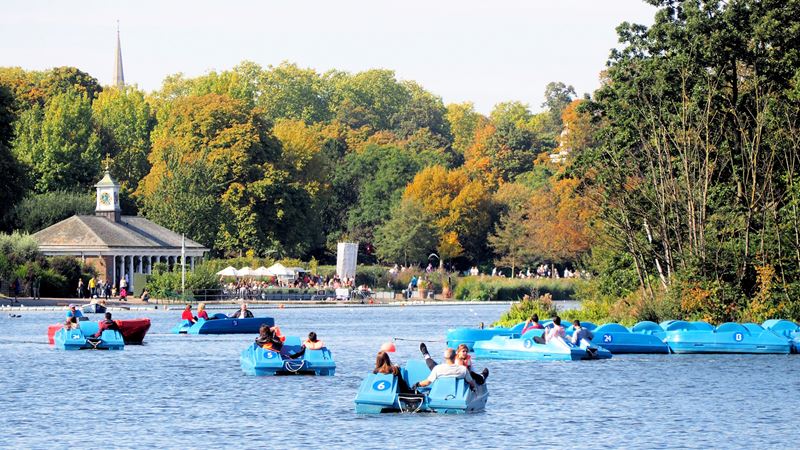 Watch the pedalos go by from a picnic spot next to the Serpentine Lake in Hyde Park. Credit: Shutterstock. Image courtesy of Shutterstock. Groups of people on pedalos on the Serpentine in Hyde Park in London on a sunny day.