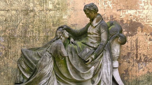 Victorian-era statue covered in moss at Kensal Green Cemetery, London