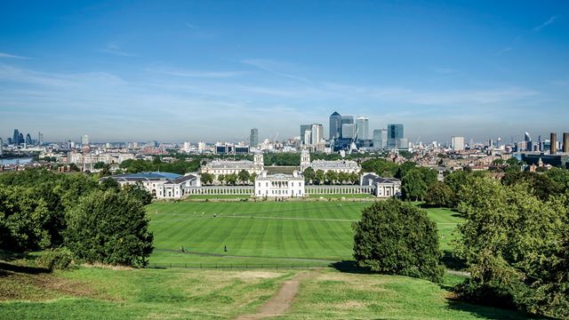 views of London and the National Maritime Museum from green lawn in Greenwich Park