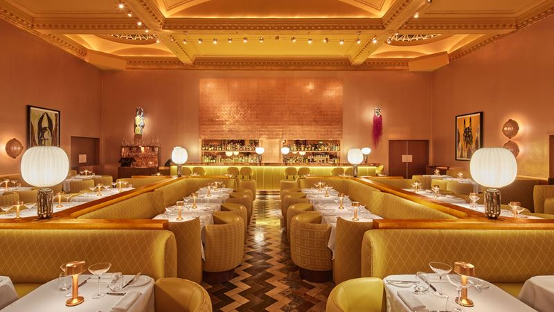 Admire the elegant interiors while you dine in The Gallery restaurant at Sketch. Credit: Edmund Dabney. Image courtesy of Sketch. The yellow and gold interior of Sketch The Gallery restaurant showing the main seating area with the bar in the background.
