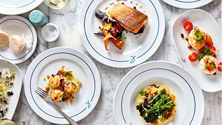 A selection of dishes on a white marble table. Credit: Steven Joyce. Image courtesy of First Restaurant Group.