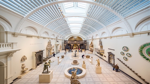 The Victoria and Albert Museum in London. © visitlondon.com/Jon Reid Landscape shot of the interior of the V&A Museum, with a large curved glass ceiling and various art exhibitions to look at