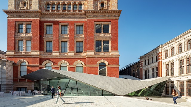 Exterior shot of Victoria and Albert Museum in London. © visitlondon.com/Jon Reid exterior shot of Victoria and Albert Museum, a period building juxtaposed by a modern glass canopy art building. bright blue skies in the background.