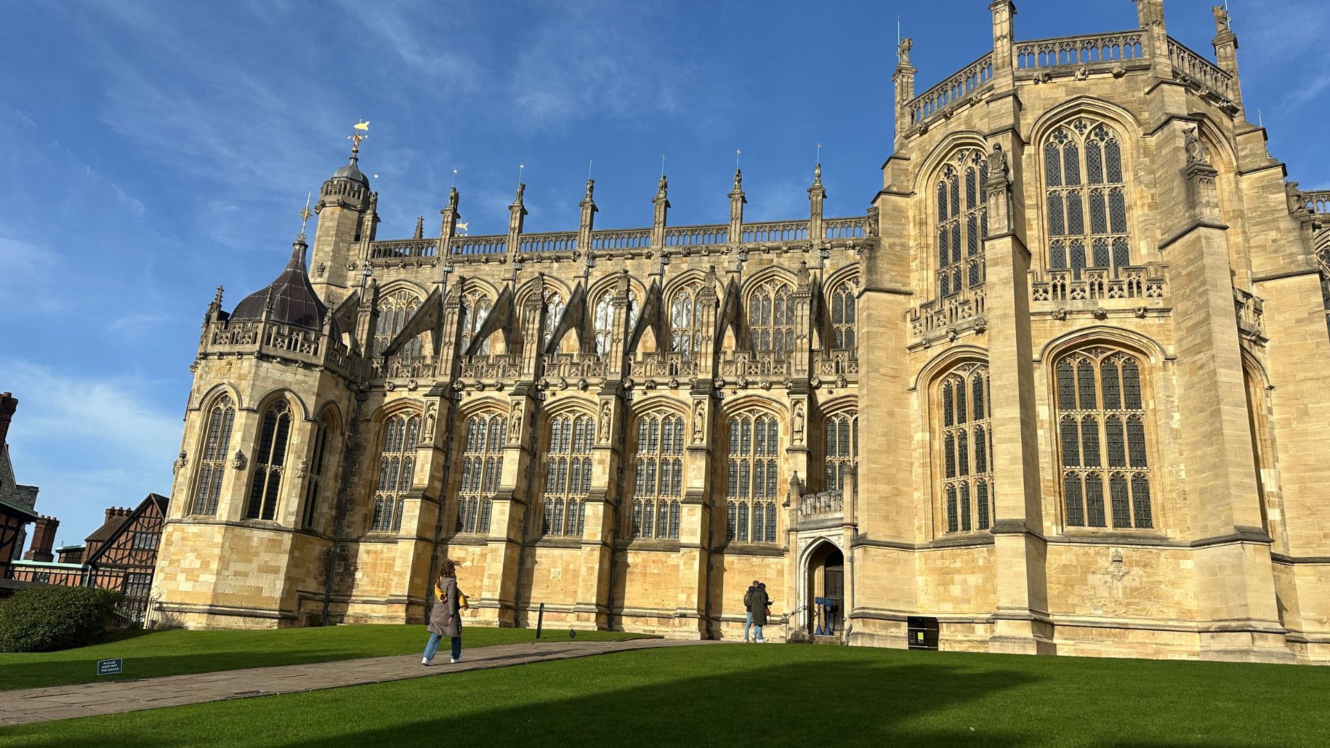 Take a look inside St George's Chapel at Windsor Castle. © Visit London/Kirstine Spicer A woman in a brown coat walks towards St George's Chapel at Windsor Castle on a sunny day.