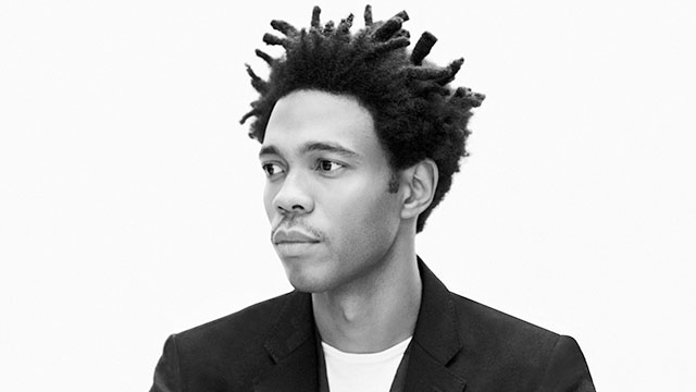 Charlie Casely-Hayford. Image courtesy of Rory van Millingen. A black-and-white image of Charlie Casely-Hayford looking off camera, wearing a suit jacket and t-shirt.