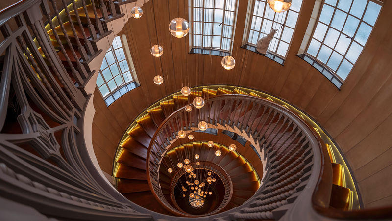 Get inspired with the stylish displays to suit every taste at the original Heal's store in central London. Credit: Shutterstock. Image courtesy of Shutterstock. A view of the winding Heal's staircase looking down with its large windows and warm orb light pendants hanging in the middle of the staircase