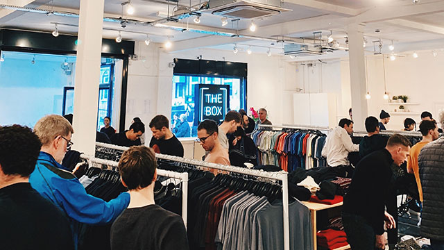 The Box London © The Box. Image courtesy of The Box. People browsing the clothes rails at The Box London