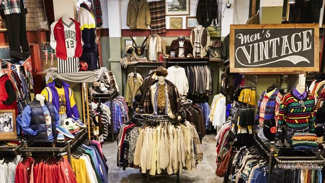 Shop the styles at Beyond Retro. Image courtesy of Beyond Retro. Inside of Beyond Retro's shop with rails of clothing and a large sign saying "Men's Vintage".