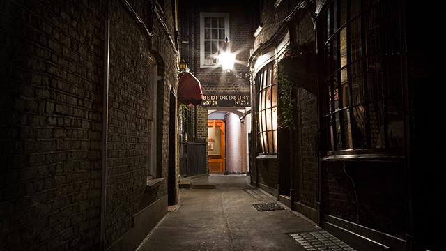 Follow in the footsteps of Jack the Ripper on a walking tour. Image courtesy of Shutterstock. Dark alleyway that's part of the Jack the Ripper Walking Tour.