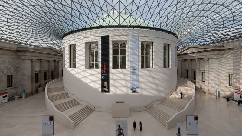 The central white building with round staircases inside the Great Court with glass roof at the British Museum in London.