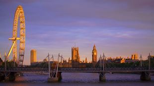 London sunrise over the river Thames with the London Eye and Big Ben in the distance. 