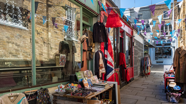 London's Camden Passage, featuring a shop selling vintage clothes, books and other secondhand goods.