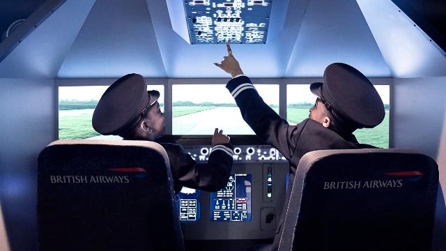 Have a go at being a pilot as part of flying activities at KidZania. Image courtesy of KidZania London. Two boys, dressed in pilot uniforms, play in the cockpit of a plane at Kidzania.