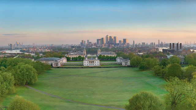 View from above of Greenwich Park, Royal Museums Greenwich, the River Thames and Canary Wharf in the distance.