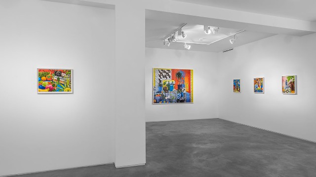 Colourful photographs exhibited in a white-walled and grey-floored gallery space at Huxley-Parlour in London.
