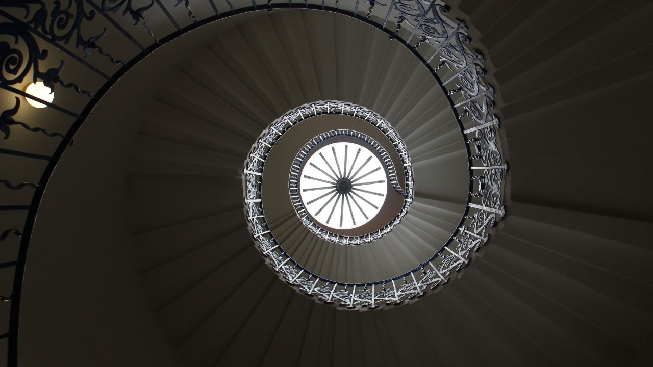 Scale the iconic spiral staircase at Queen's House. © Unsplash/Sven D The spiral staircase in the queens house in london.