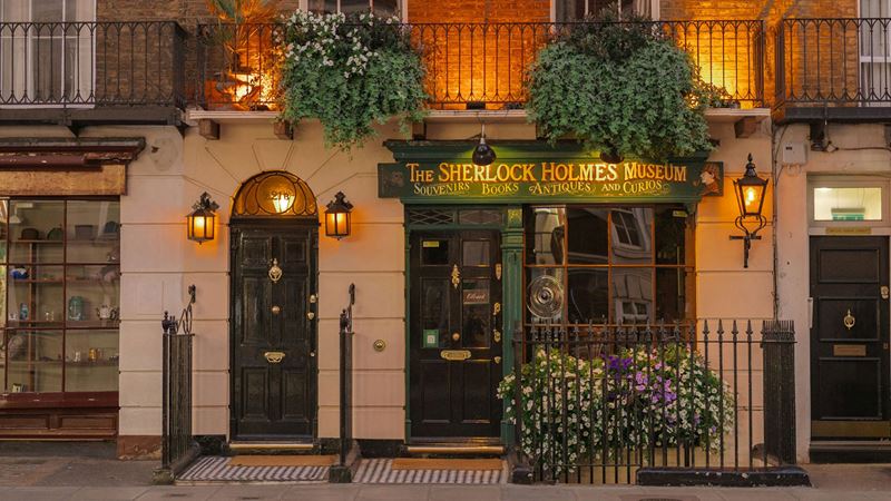 Visit The Sherlock Holmes Museum at 221b Baker Street. Credit: Huan Yu. Image courtesy of Unsplash. The green shop front of the Sherlock Holmes Museum at 221b Baker Street in London in the evening light.