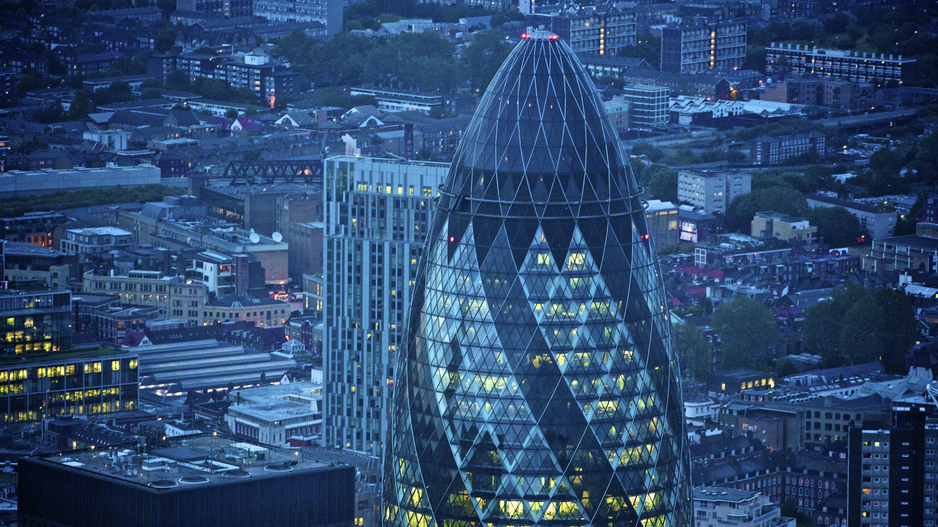 For fantastic skyline views, step inside The Gherkin, one of London's most iconic buildings. Credit: petewebb.com. Image courtesy of London and Partners. An aerial shot of The Gherkin and the City of London lit up at night. © petewebb.com/London and Partners