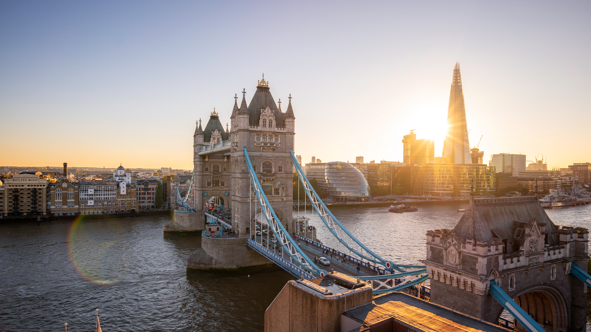 Sunrise at Tower Bridge. Image courtesy of Visit London/Antoine Buchet. The sun rising behind The Shard and Tower Bridge