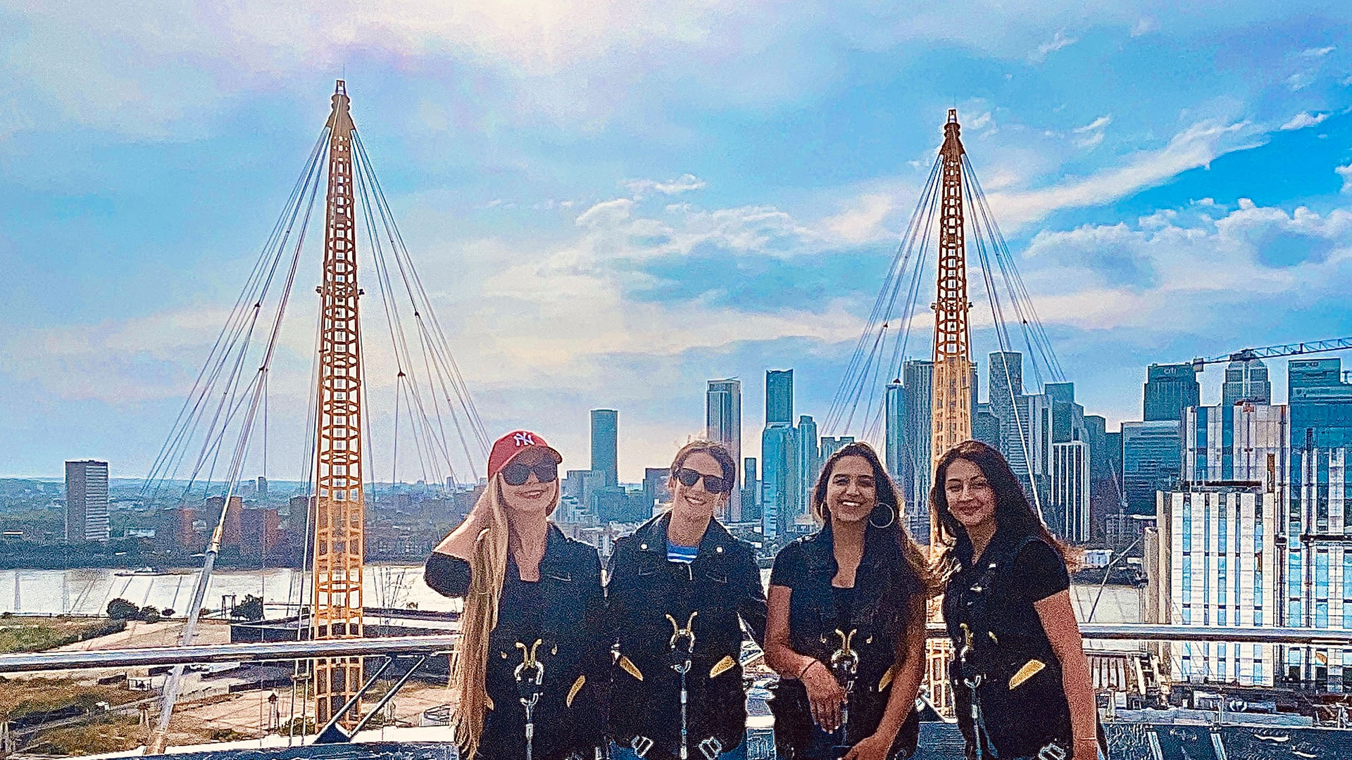 Reaching the summit of the O2 Arena © Chantal Welch. Image courtesy of Chantal Welch. A group of women standing on the viewing platform Up at The O2, with the London skyline behind them on a sunny day